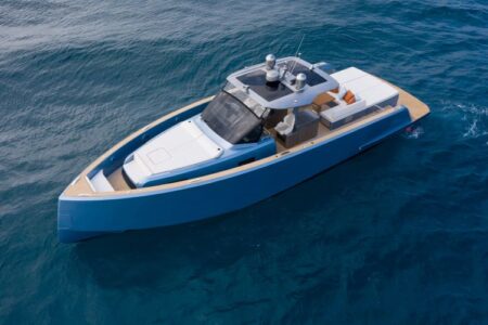 Pardo P50 yacht with blue hull and white deck cruising on calm blue water